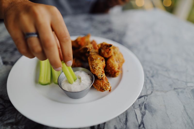 Buffalo wings with celery sticks and blue cheese dip